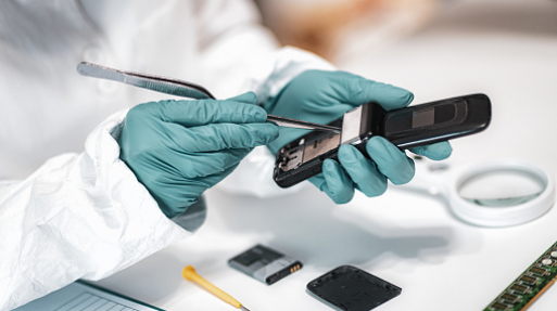 Digital Forensic Science. Police Forensic Analyst Examining Confiscated Mobile Phone.